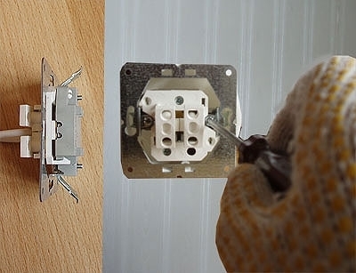 Užsukami išskleidžiamųjų kablių varžtai. Kabliai pritvirtina įtaisą dėžutės viduje. Autoriaus nuotr. Užsukami išskleidžiamųjų kablių varžtai. Kabliai pritvirtina įtaisą dėžutės viduje. Autoriaus nuotr.